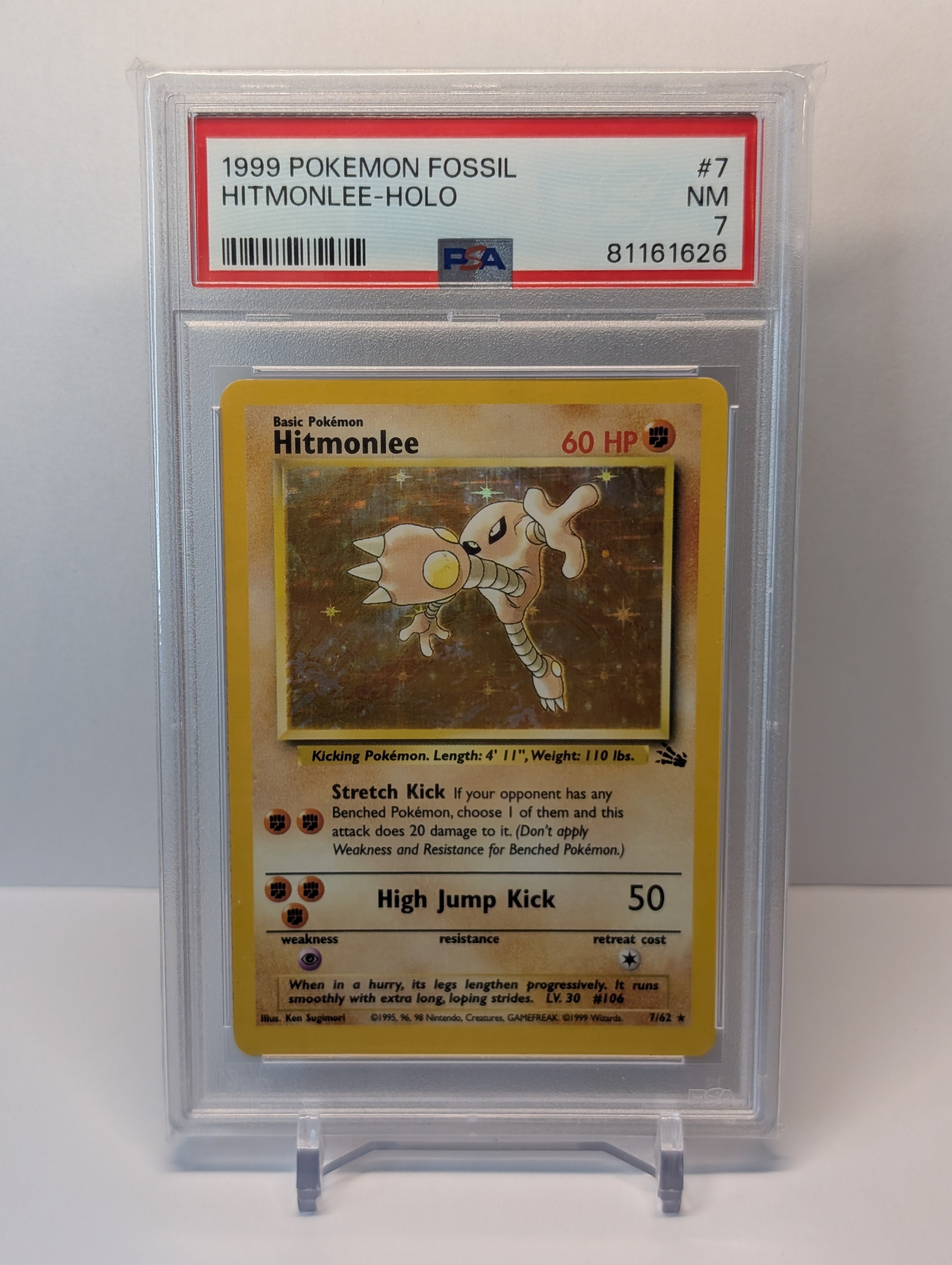PSA 7 - Hitmonlee - 7/64 - Fossil